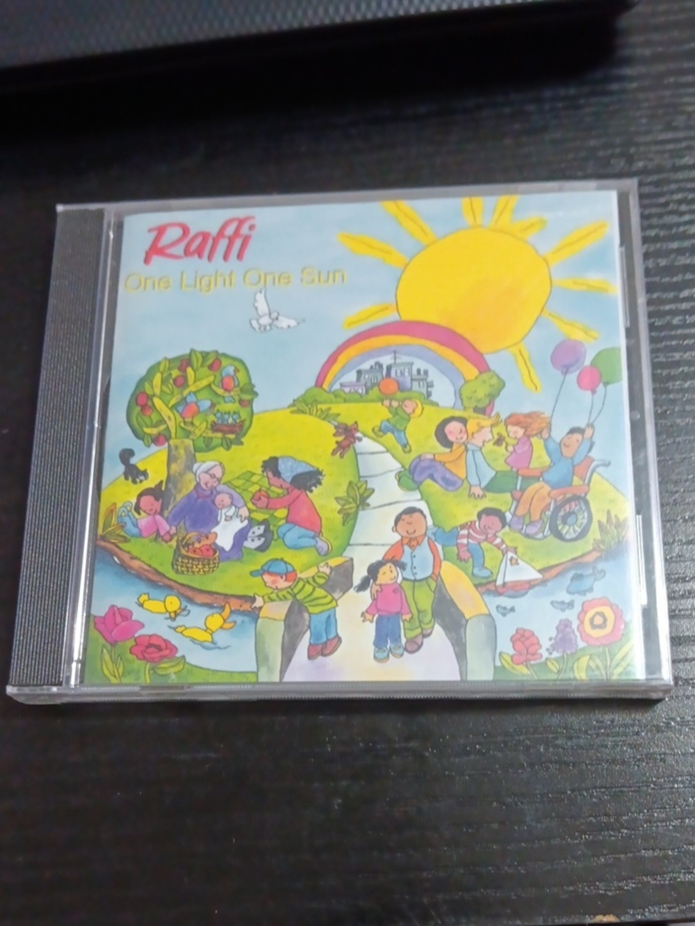 Raffi Colorful Family Scene CD with Bright Yellow Sun and Green Hills